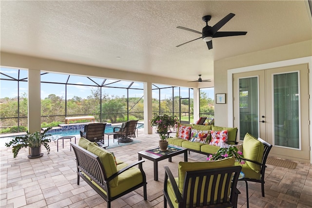 sunroom / solarium featuring ceiling fan and a pool