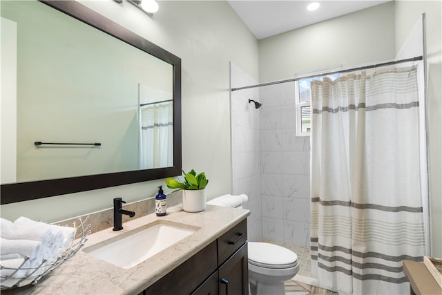 bathroom with vanity, curtained shower, and toilet