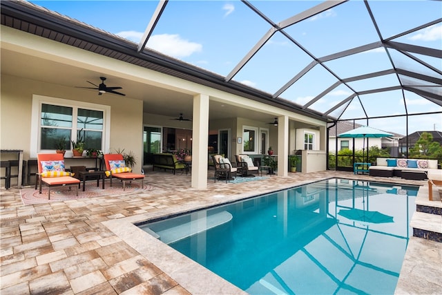 view of swimming pool featuring a lanai, ceiling fan, a patio, and an outdoor living space