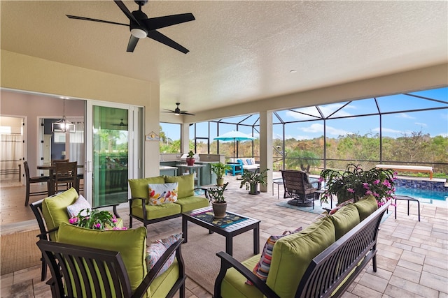 view of patio with a lanai, outdoor lounge area, and ceiling fan