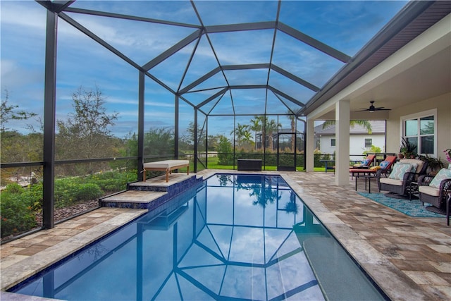 view of pool featuring ceiling fan, a lanai, a patio, and an outdoor hangout area