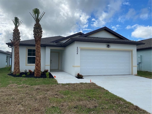 single story home with a garage and a front yard