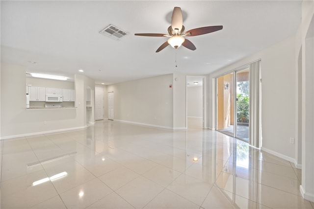 unfurnished room featuring ceiling fan and light tile patterned floors