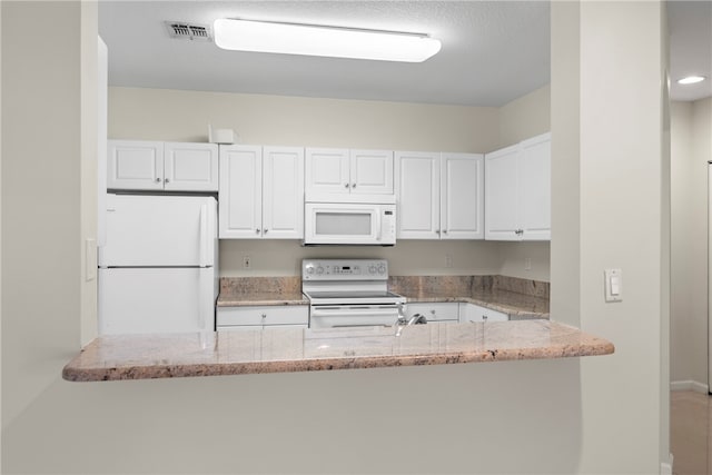 kitchen featuring white cabinets, white appliances, kitchen peninsula, and light stone countertops