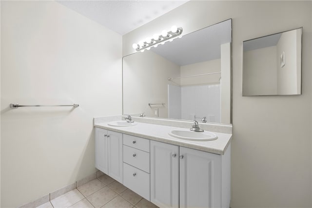 bathroom with tile patterned floors and vanity