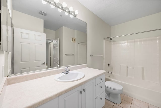 full bathroom featuring tile patterned floors, tub / shower combination, a textured ceiling, vanity, and toilet