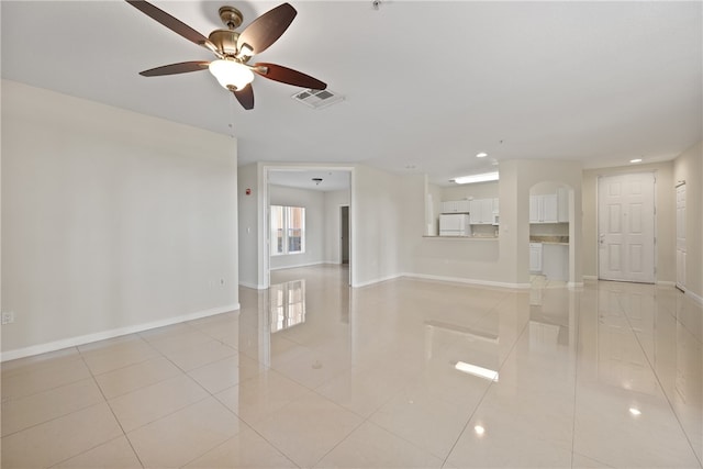 empty room with light tile patterned floors and ceiling fan