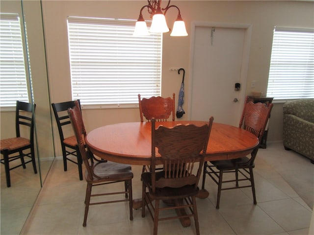 dining room featuring a wealth of natural light, light tile patterned floors, and a chandelier