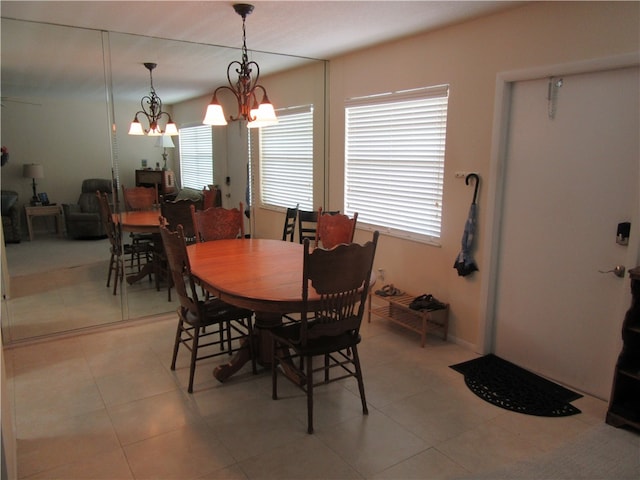 tiled dining area with an inviting chandelier