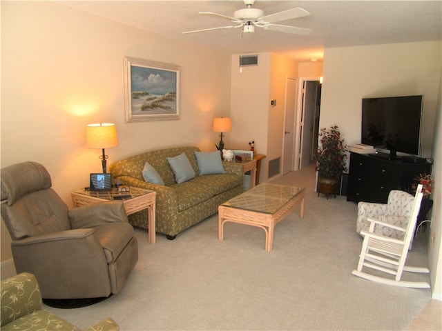 carpeted living room featuring ceiling fan