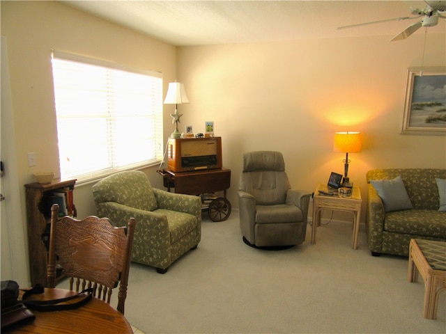 carpeted living room featuring ceiling fan