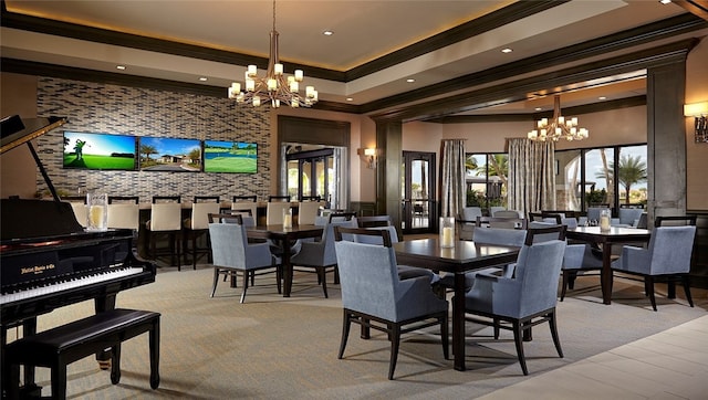 dining room featuring crown molding, a healthy amount of sunlight, and an inviting chandelier