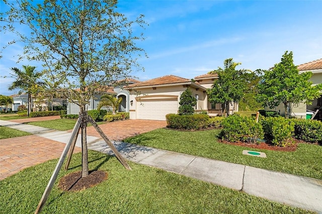 mediterranean / spanish home featuring a garage and a front lawn