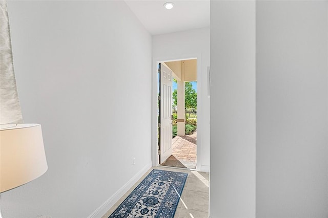 doorway with light tile patterned flooring