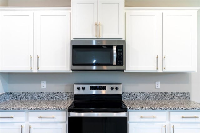 2115 Crowned Eagle Cir SW, Vero Beach, FL 32962 - kitchen with appliances with stainless steel finishes, white cabinets, and light stone counters