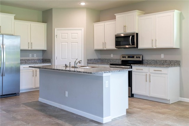 2115 Crowned Eagle Cir SW, Vero Beach, FL 32962 - kitchen with stainless steel appliances, an island with sink, white cabinetry, recessed lighting, and stone counters