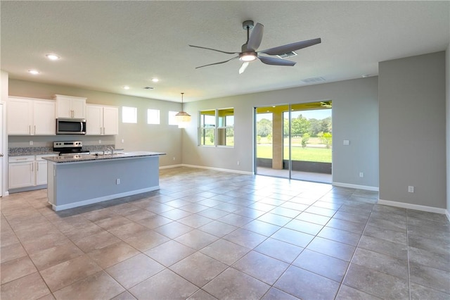 2115 Crowned Eagle Cir SW, Vero Beach, FL 32962 - kitchen with stainless steel appliances, open floor plan, ceiling fan, recessed lighting, and white cabinets
