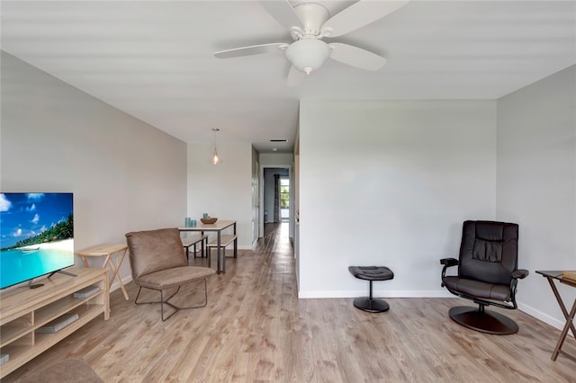 sitting room featuring light hardwood / wood-style floors and ceiling fan