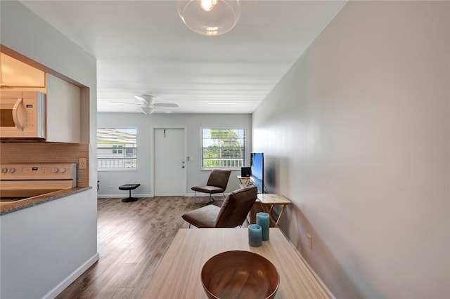 living room featuring hardwood / wood-style floors and ceiling fan