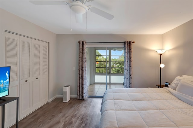 unfurnished bedroom featuring a closet, access to outside, wood-type flooring, and ceiling fan