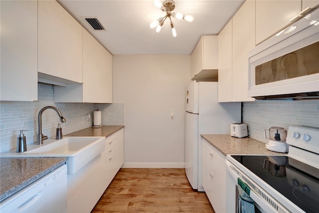 kitchen featuring light hardwood / wood-style floors, white cabinetry, sink, white appliances, and decorative backsplash