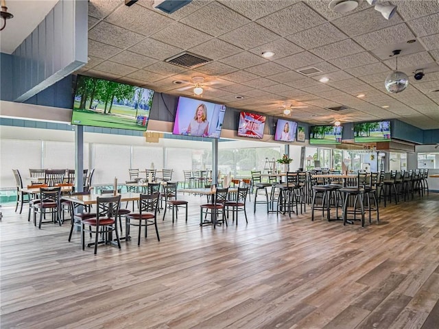 dining room featuring visible vents, wood finished floors, and ceiling fan
