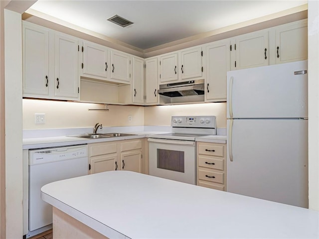 kitchen with a sink, visible vents, white appliances, under cabinet range hood, and light countertops