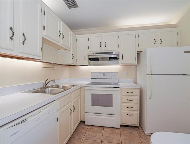 kitchen with light tile patterned floors, range hood, white appliances, a sink, and light countertops