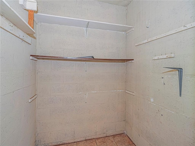walk in closet with light tile patterned flooring