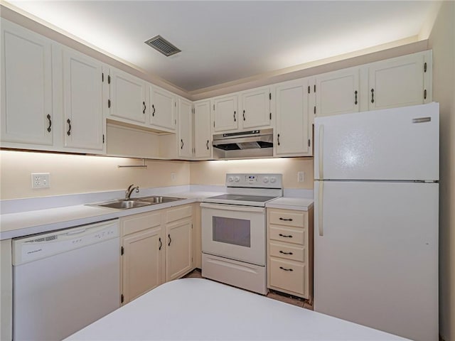 kitchen with a sink, visible vents, white appliances, under cabinet range hood, and light countertops