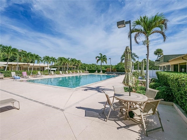 community pool with a patio area