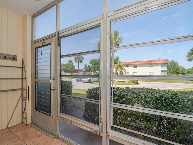 doorway to outside featuring tile patterned flooring