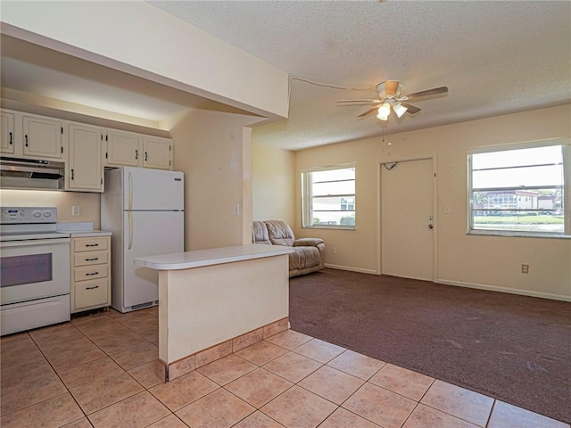kitchen with open floor plan, exhaust hood, white appliances, light carpet, and light tile patterned flooring