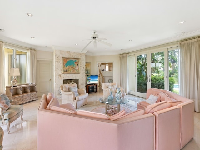 tiled living room with a premium fireplace, ceiling fan, and crown molding