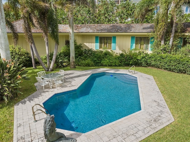 view of pool with a yard and a patio