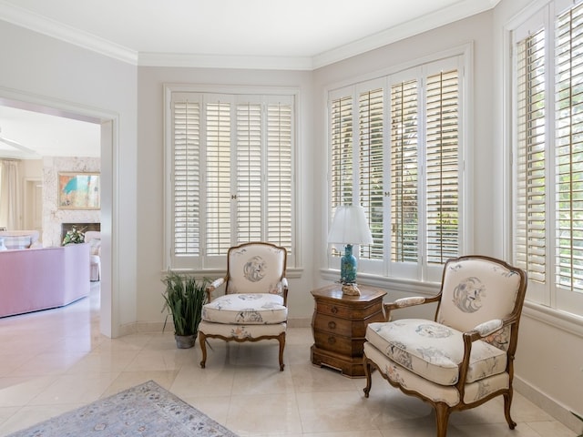 living area with plenty of natural light, light tile patterned floors, and ornamental molding