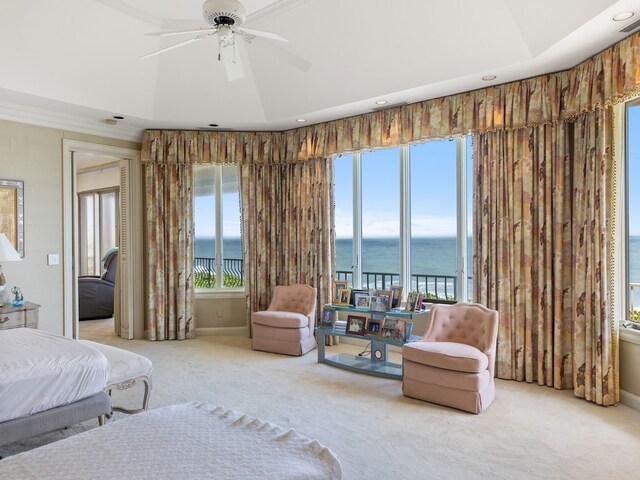 bedroom with ceiling fan, a water view, multiple windows, and carpet flooring