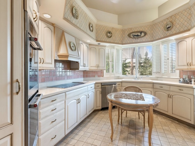 kitchen with tasteful backsplash, premium range hood, black stovetop, sink, and stainless steel dishwasher