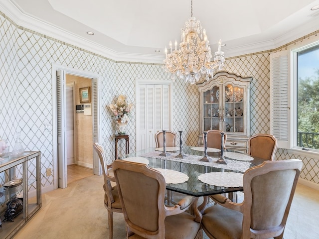 carpeted dining space featuring an inviting chandelier, crown molding, and a raised ceiling