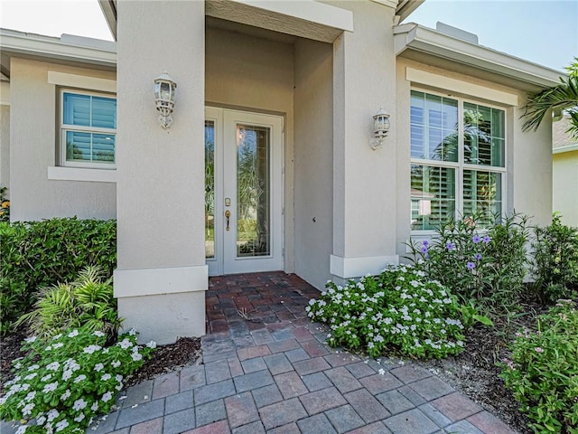 2284 Timberlake Cir, Vero Beach, FL 32966 - view of exterior entry featuring french doors and stucco siding