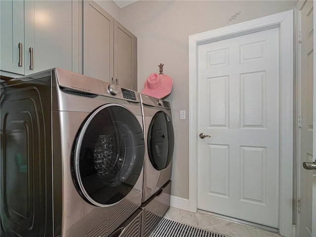 2284 Timberlake Cir, Vero Beach, FL 32966 - laundry area with cabinet space, separate washer and dryer, and light tile patterned flooring