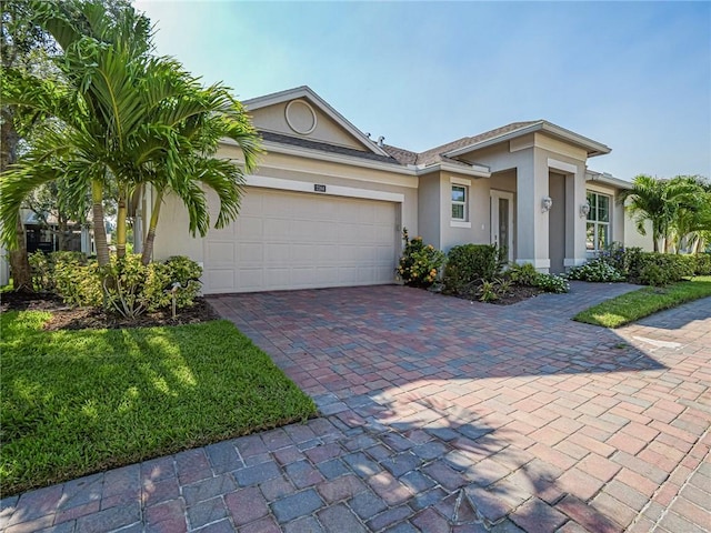 2284 Timberlake Cir, Vero Beach, FL 32966 - view of front facade featuring stucco siding, decorative driveway, and a garage