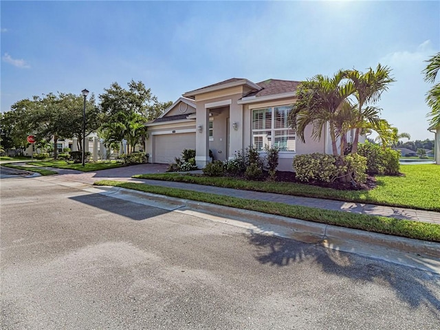 2284 Timberlake Cir, Vero Beach, FL 32966 - ranch-style home featuring stucco siding, a garage, and driveway