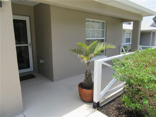 1465 24th Ave SW, Vero Beach, FL 32962 - doorway to property with stucco siding