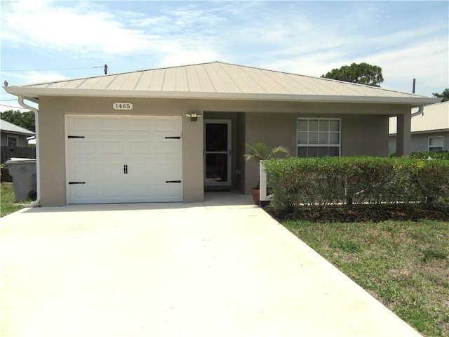 1465 24th Ave SW, Vero Beach, FL 32962 - view of front of home with a garage, stucco siding, and concrete driveway