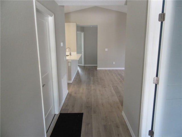 1465 24th Ave SW, Vero Beach, FL 32962 - hall with light wood-style flooring, lofted ceiling, and baseboards