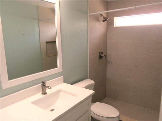 1465 24th Ave SW, Vero Beach, FL 32962 - bathroom featuring toilet, vanity, and a tile shower