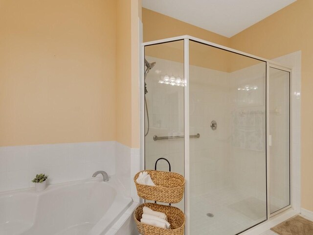 7639 15th Ln, Vero Beach, FL 32966 - bathroom featuring a shower stall and a garden tub