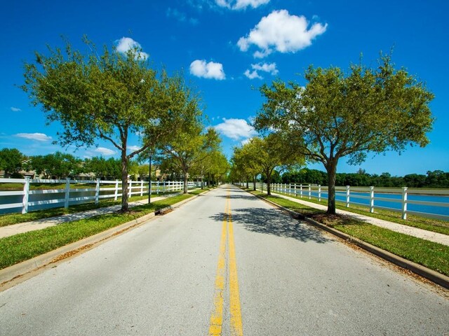 7639 15th Ln, Vero Beach, FL 32966 - view of asphalt street with sidewalks and curbs