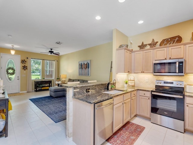 7639 15th Ln, Vero Beach, FL 32966 - kitchen featuring appliances with stainless steel finishes, a sink, light brown cabinetry, open floor plan, and recessed lighting